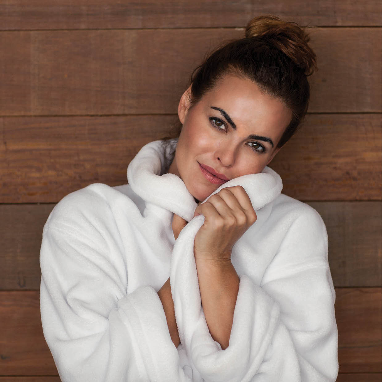 Lady feeling comfy In Hotel Bathrobe